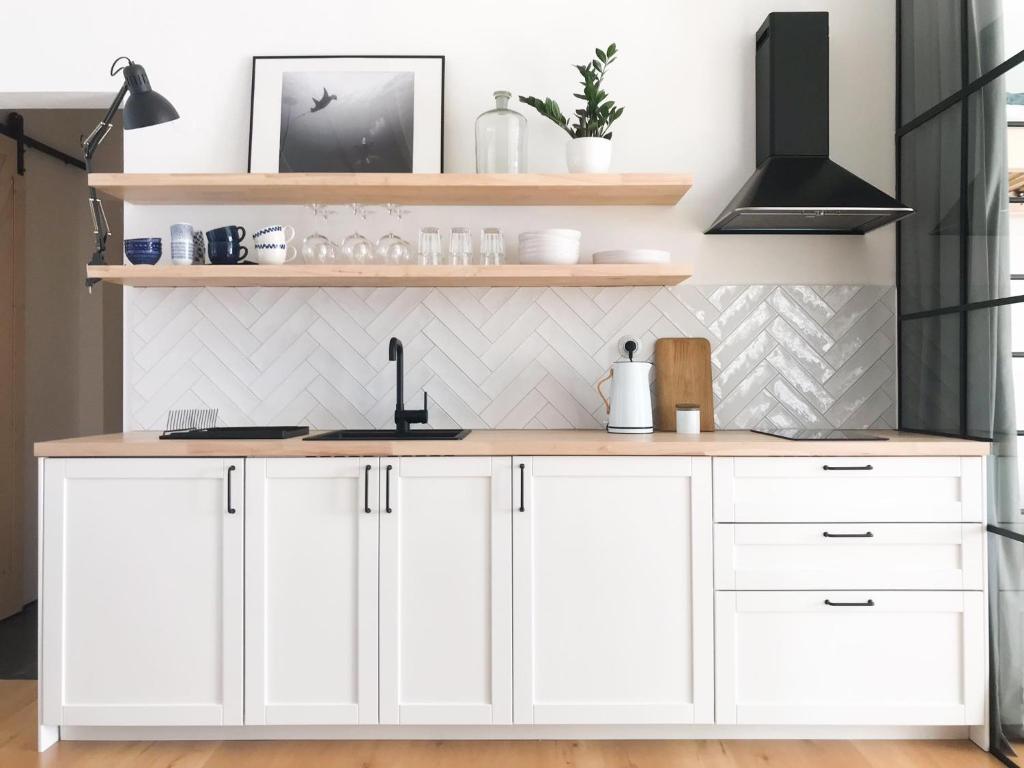 a kitchen with white cabinets and a sink at Apartmán TYRŠOVKA in Svoboda nad Úpou