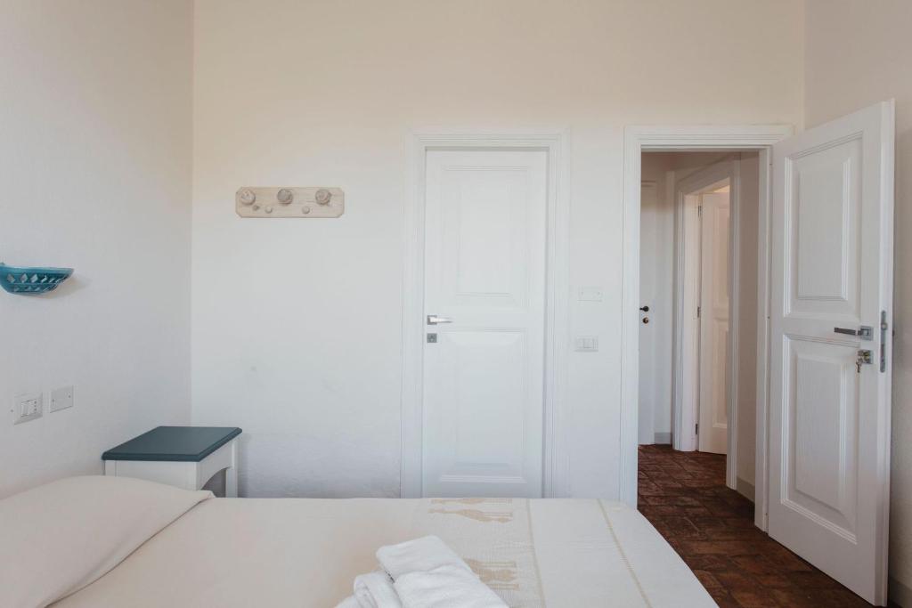 Postel nebo postele na pokoji v ubytování Resort Fior di Sardegna