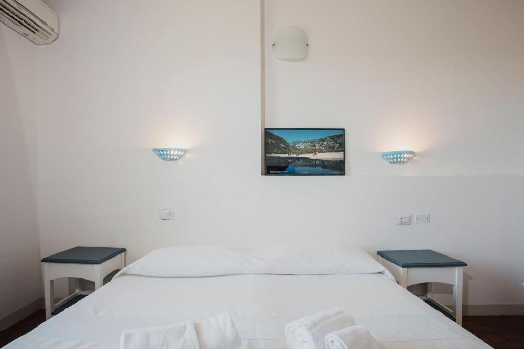 Postel nebo postele na pokoji v ubytování Resort Fior di Sardegna