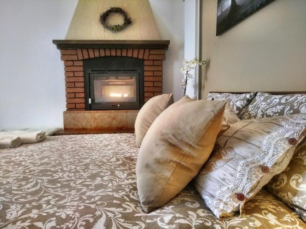 a bedroom with a bed with pillows and a fireplace at Casa Ronzani B&B in Salcedo