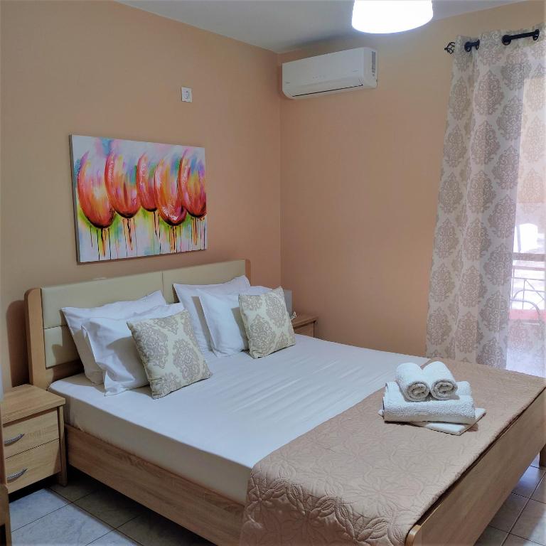 a bedroom with a large bed with towels on it at Nini's House 1 Nydri - 100m from beach NYDRI TOWN CENTER in Nydri