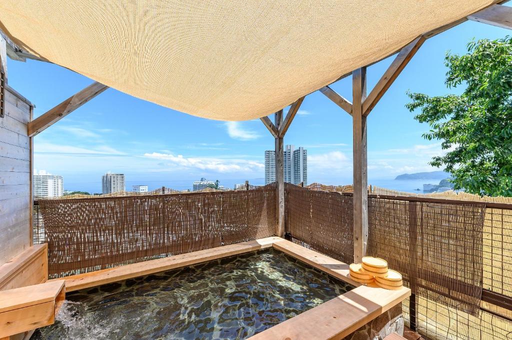 a hot tub on the roof of a building at Lectore Atami Momoyama - TKP Hotels & Resorts in Atami