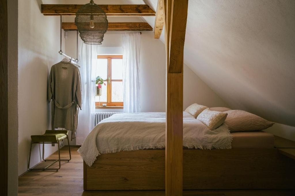 a bedroom with a canopy bed in a attic at Marináda Viniční dům in Pavlov