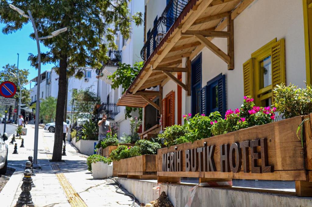a building with a sign that reads hollybush house at merih butik hotel in Bodrum City