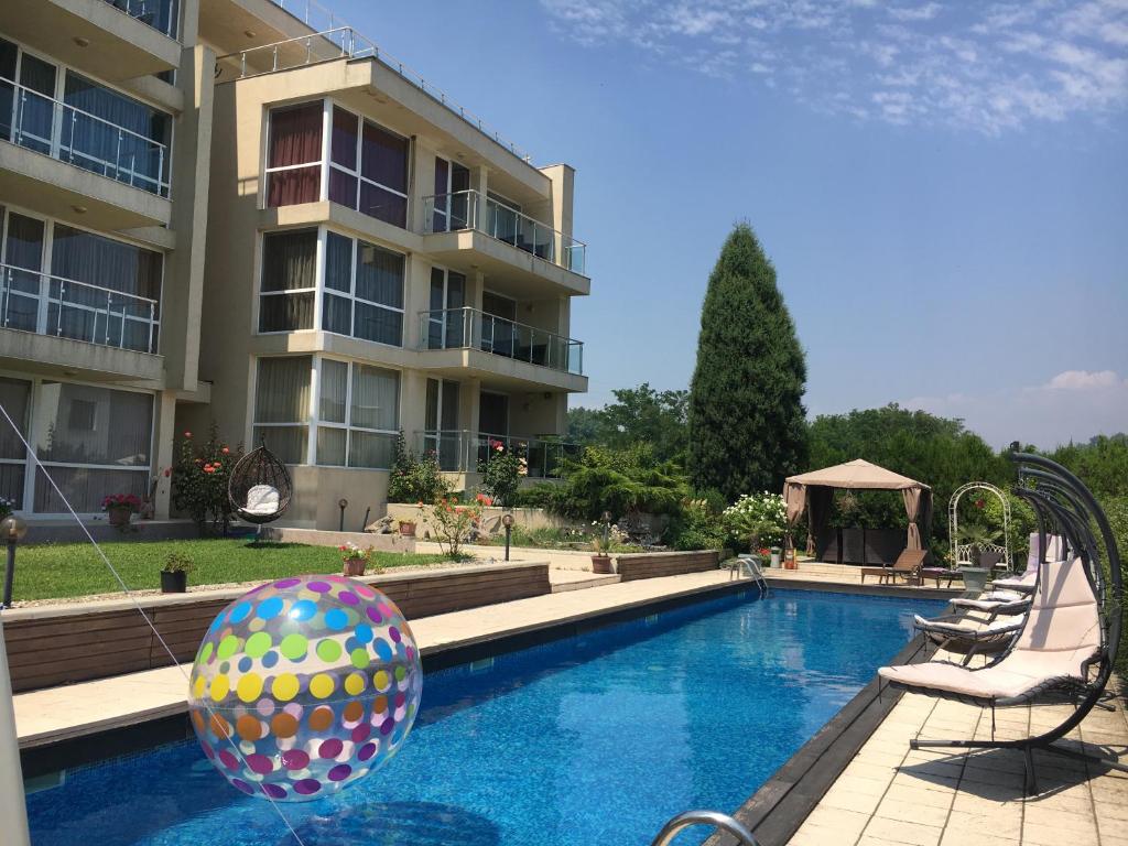 a swimming pool with a ball in front of a building at Sea Dream Rental Apartments in Varna City