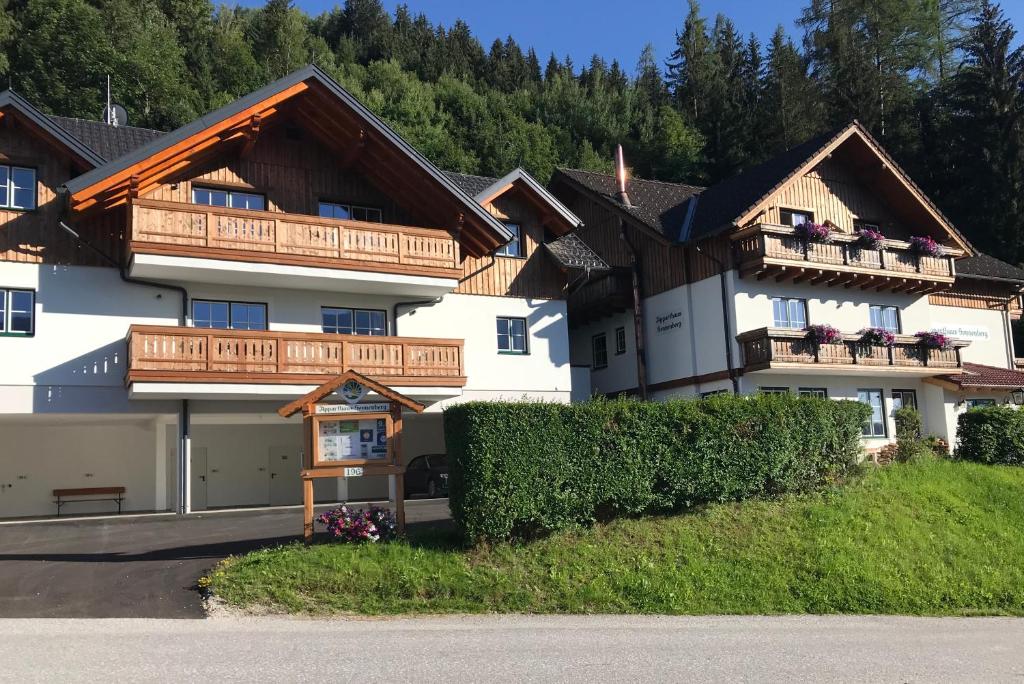 a large white building with wooden balconies on it at Hirschberg in Haus im Ennstal