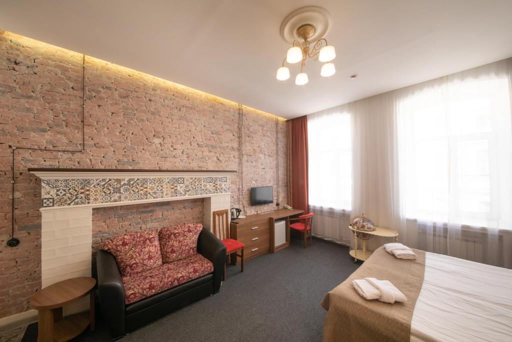a hotel room with a bed and a fireplace at Talisman Gorokhovaya in Saint Petersburg