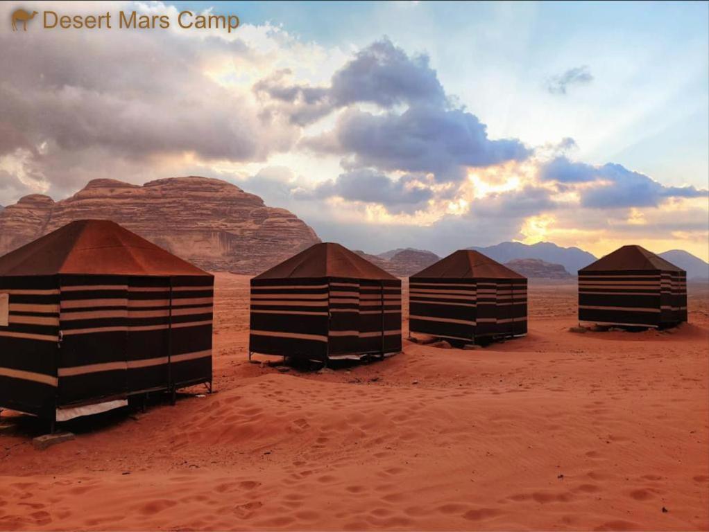 a group of five huts in the desert at Desert Mars Camp & Tours in Wadi Rum