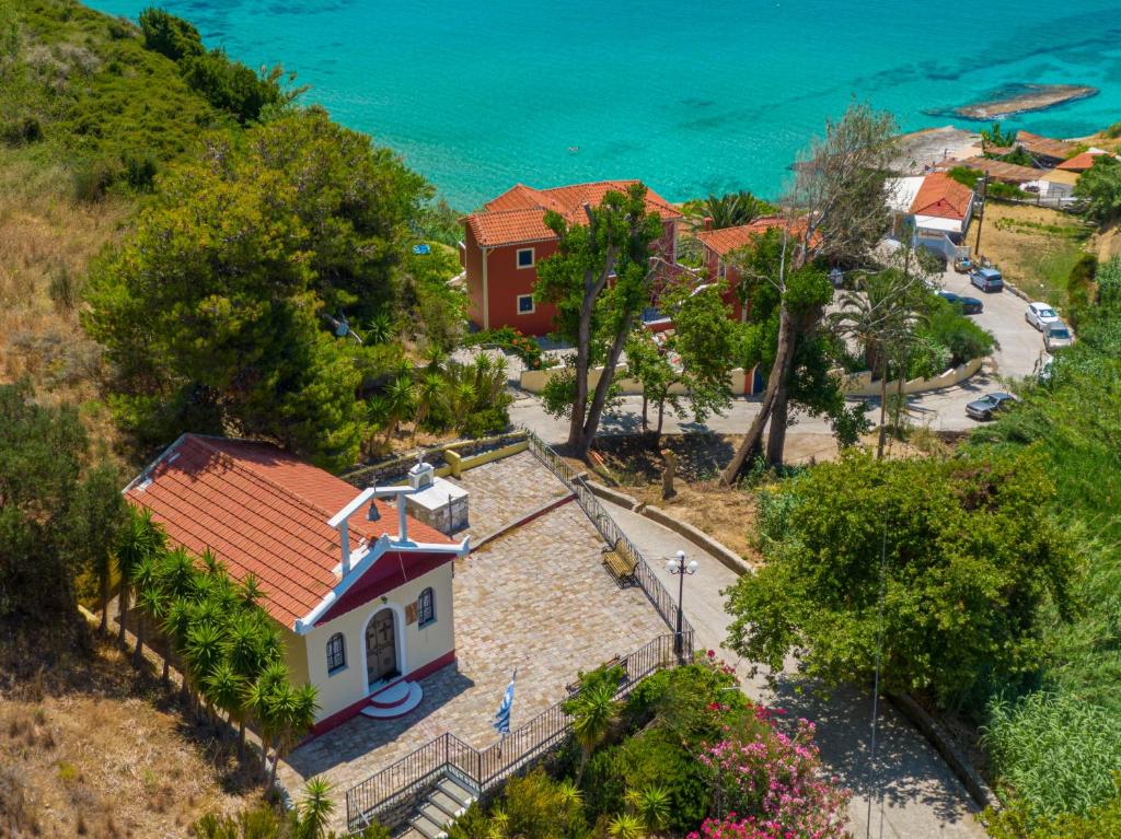 an aerial view of a church with the ocean behind it at Aloe Studios, Waterfront Accommodation in Karavadhos