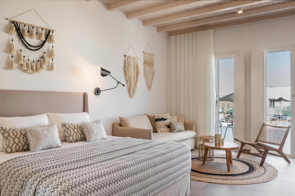 a bedroom with a bed and a couch at Amyth of Mykonos Super Paradise in Super Paradise Beach