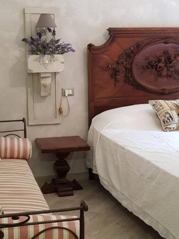 Postel nebo postele na pokoji v ubytování Nel giardino di Dafne