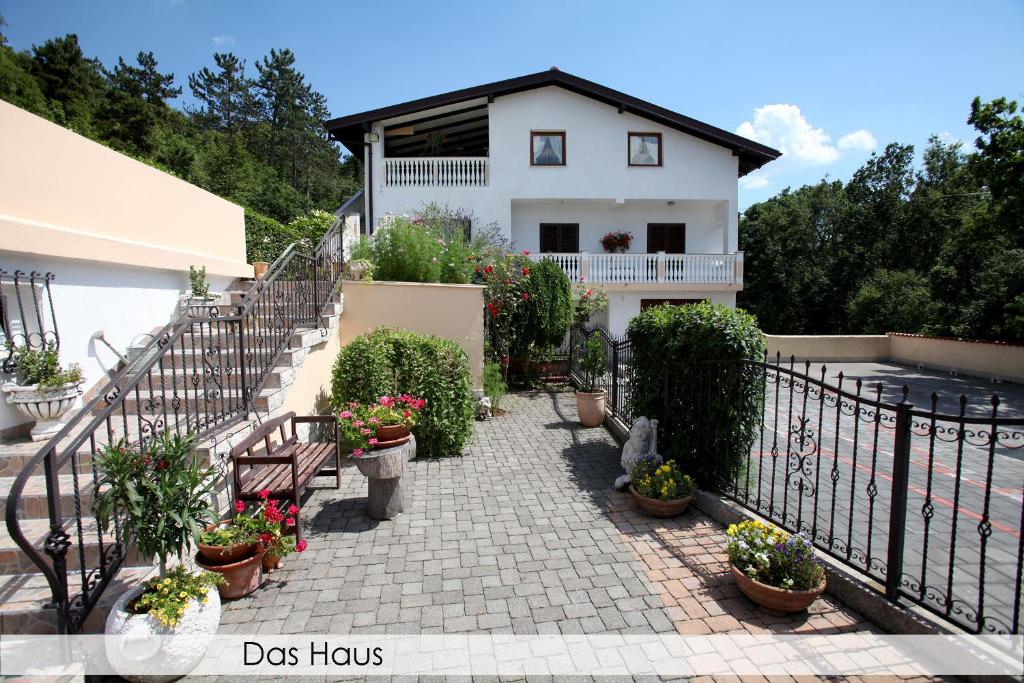a house with a staircase with potted plants at Anica Iles in Viskovo