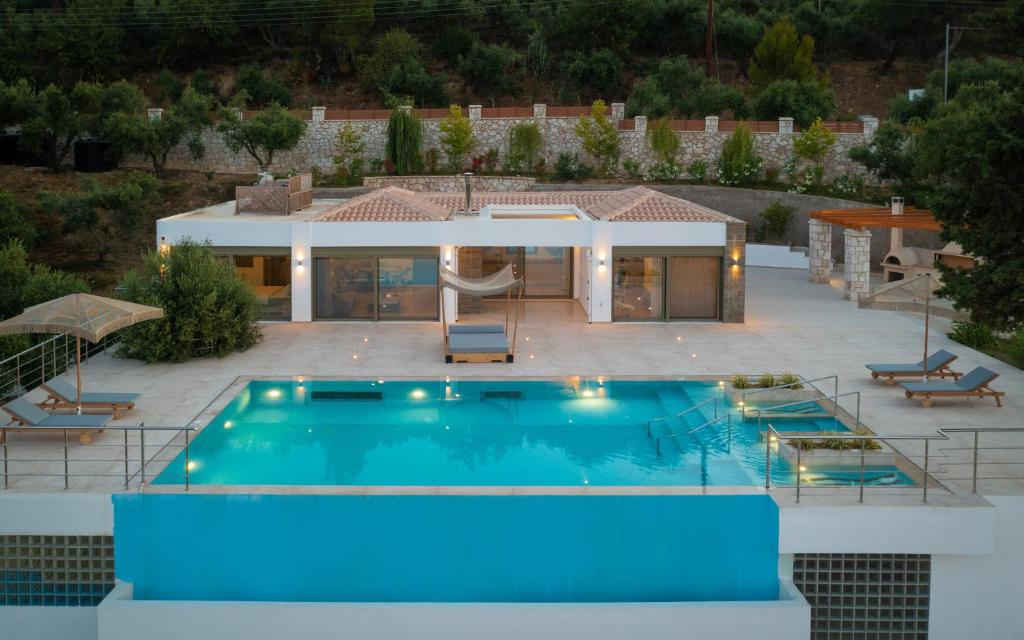 a swimming pool in front of a house at Villa Anna in Zakynthos Town