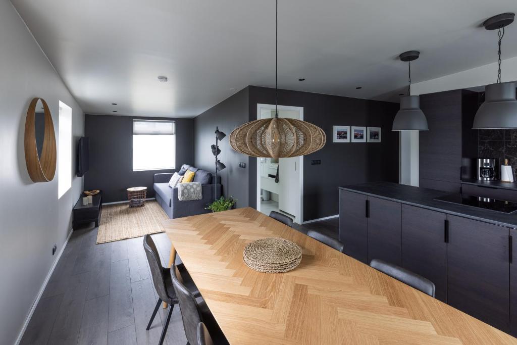 a kitchen and dining room with a wooden table at Acco Luxury Apartments in Akureyri