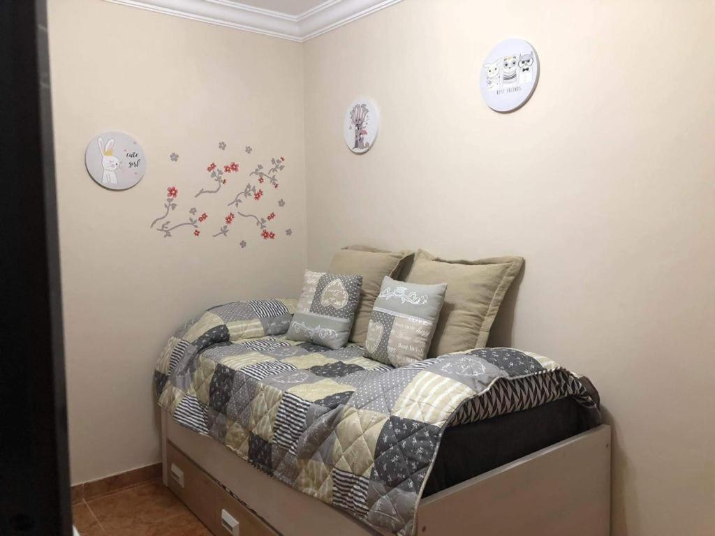 a bedroom with a bed and clocks on the wall at LAS CANTERAS in Las Palmas de Gran Canaria