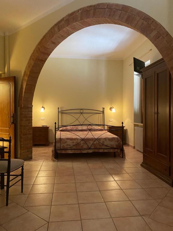 A bed or beds in a room at Affittacamere La Torre di Montalcino