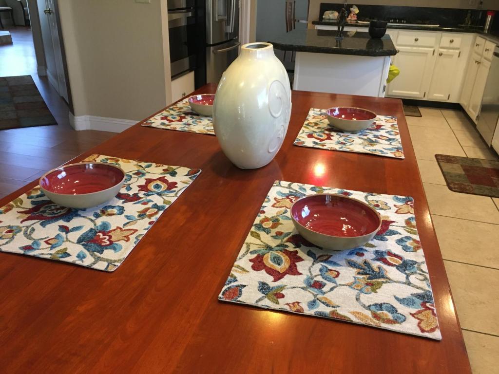 a table with three bowls and a vase on it at Enchanted room in Las Vegas