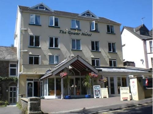 a large building with a sign in front of it at The Gower Hotel in Saundersfoot