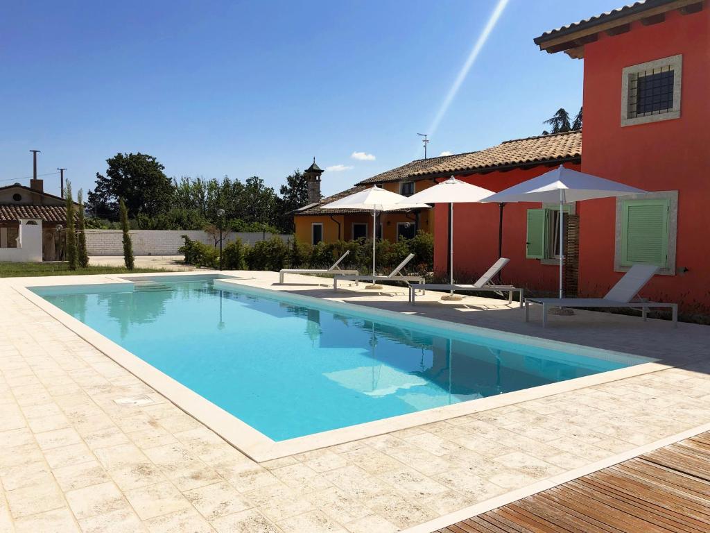 a swimming pool in front of a house at Relais Gregorio in Paternopoli