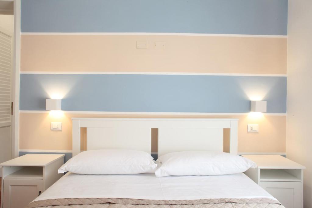 a bedroom with a bed with two white pillows at Country Villa San Vito Bay in San Vito lo Capo