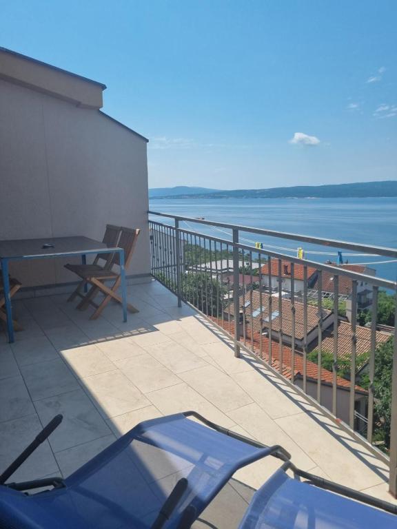 a balcony with a view of the ocean at Apartmani Tanja in Dramalj