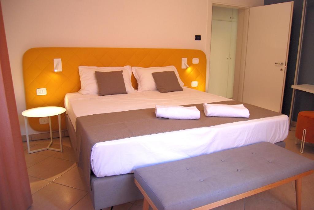 a bedroom with a large bed with two pillows at Taormina Suite Bardolino in Bardolino
