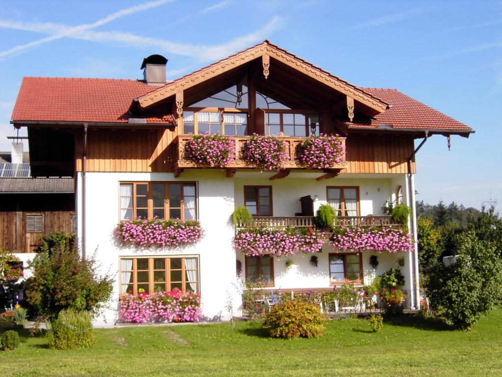 a house with flower boxes on the front of it at Ferienwohnung Zottnerhof in Frasdorf