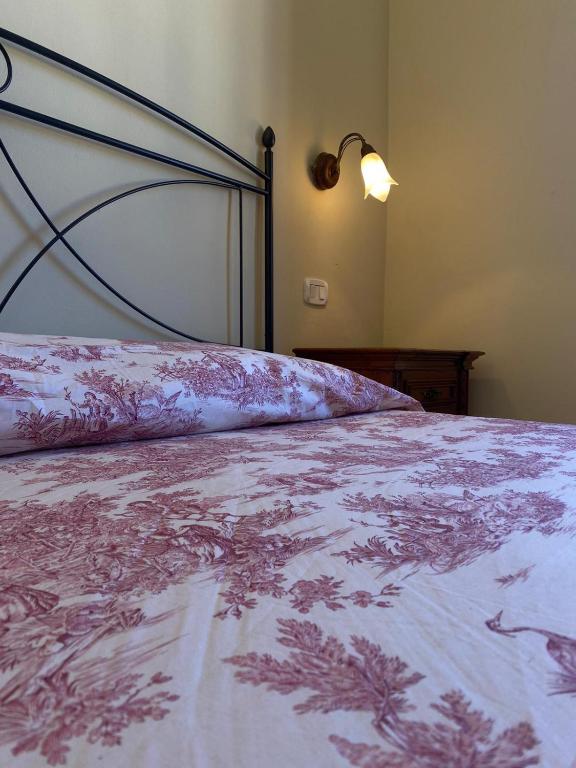 A bed or beds in a room at Affittacamere La Torre di Montalcino