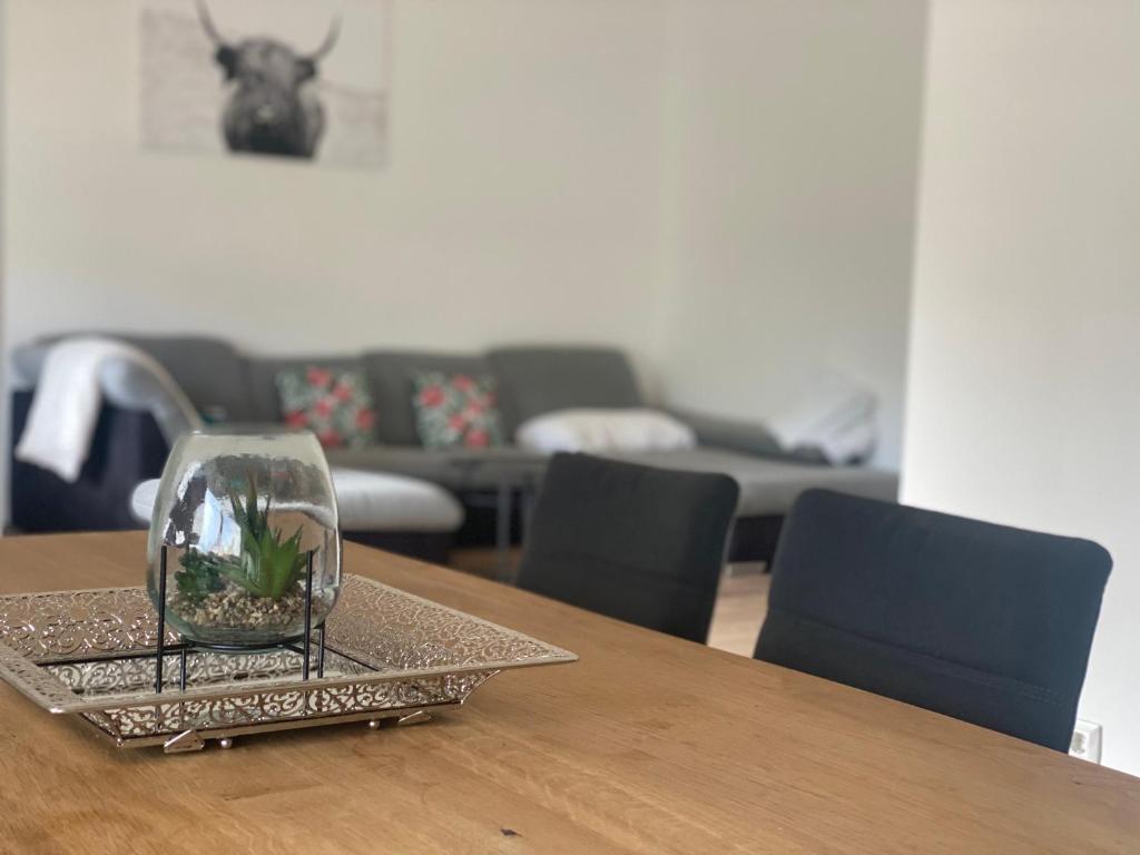 a glass vase sitting on top of a wooden table at Apartment mit Parkblick in Gratkorn