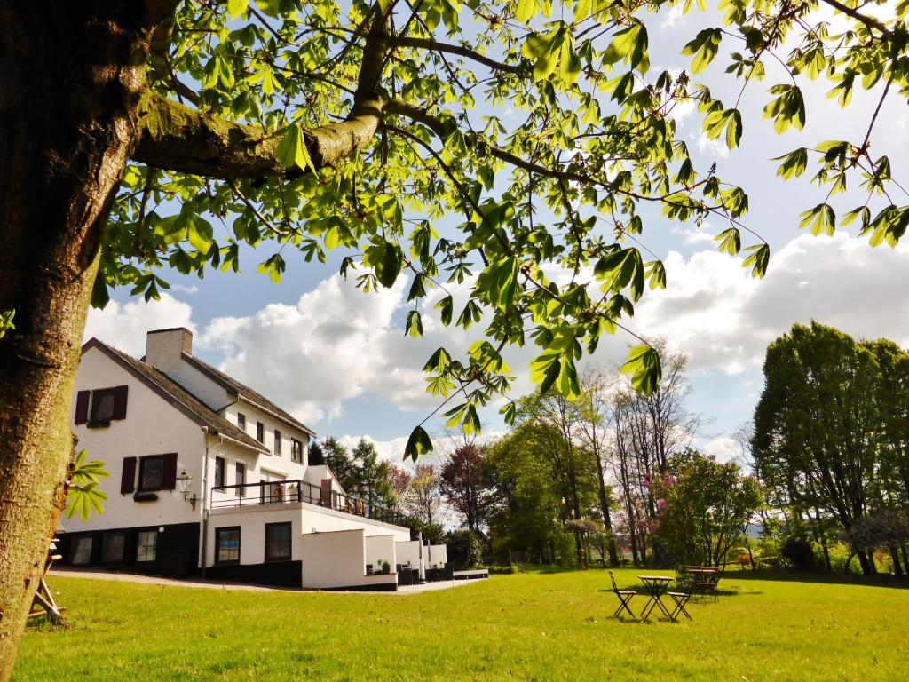 a large white building with a picnic table in a field at Villa Witte Lelie in Mechelen