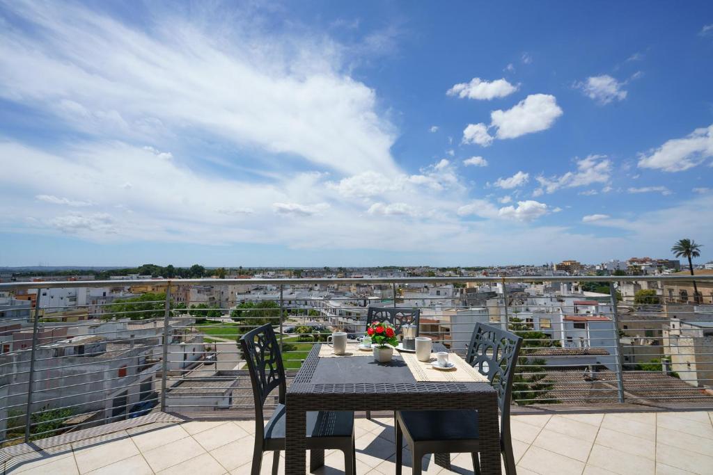 a table on a balcony with a view of a city at Atmosphera in Galatina