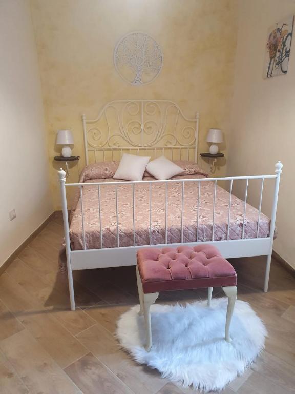a bedroom with a white bed with a white frame at B&B Castrum in Santo Padre