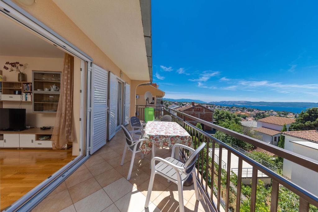 a balcony with a table and chairs and a view at Apartments Nada in Selce