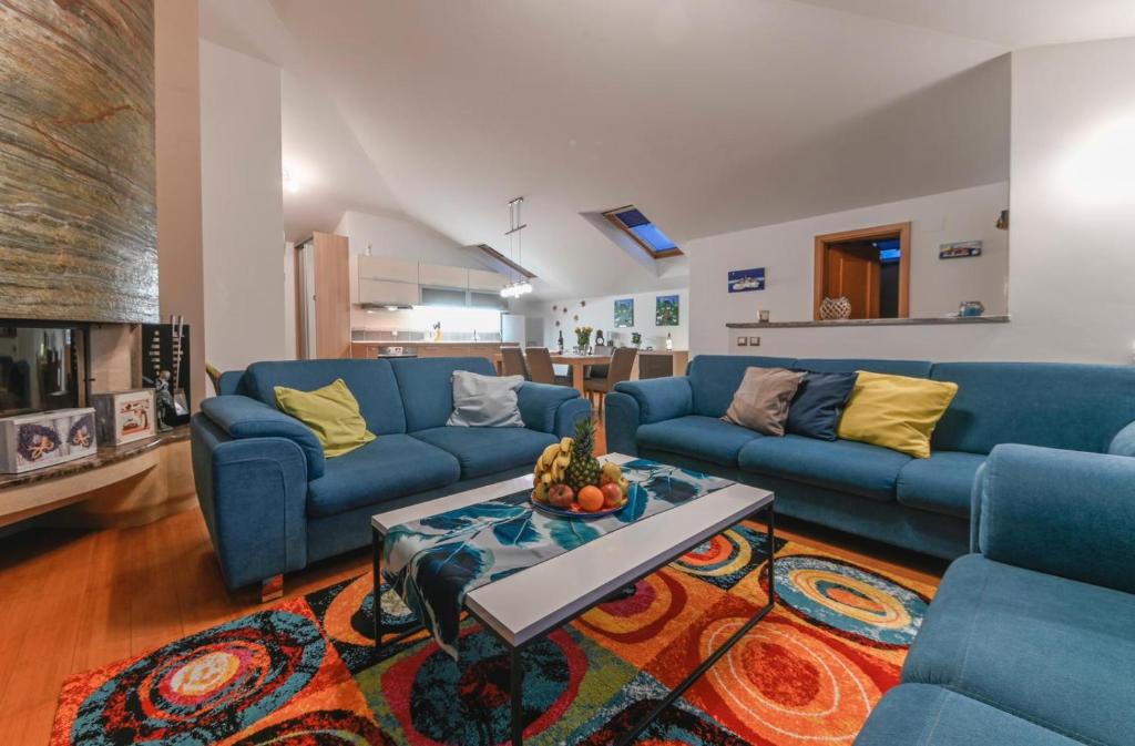 a living room with blue couches and a table at HEDKO Apartment in Makarska