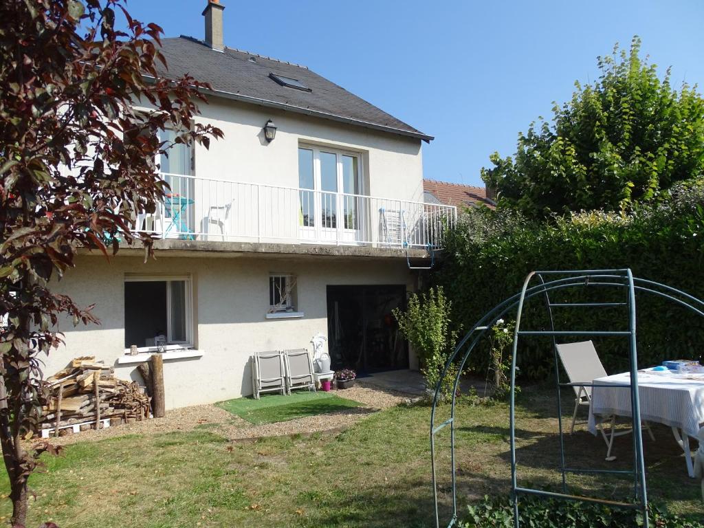 a house with a table and chairs in a yard at 13Tours in Tours