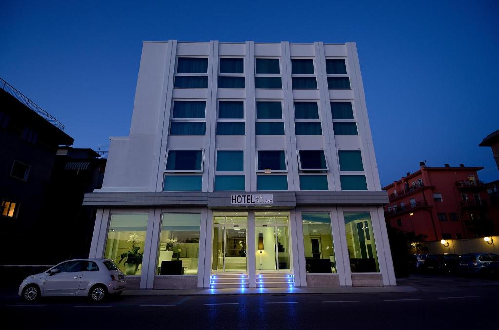 a white car parked in front of a building at Hotel San Giuliano in Mestre