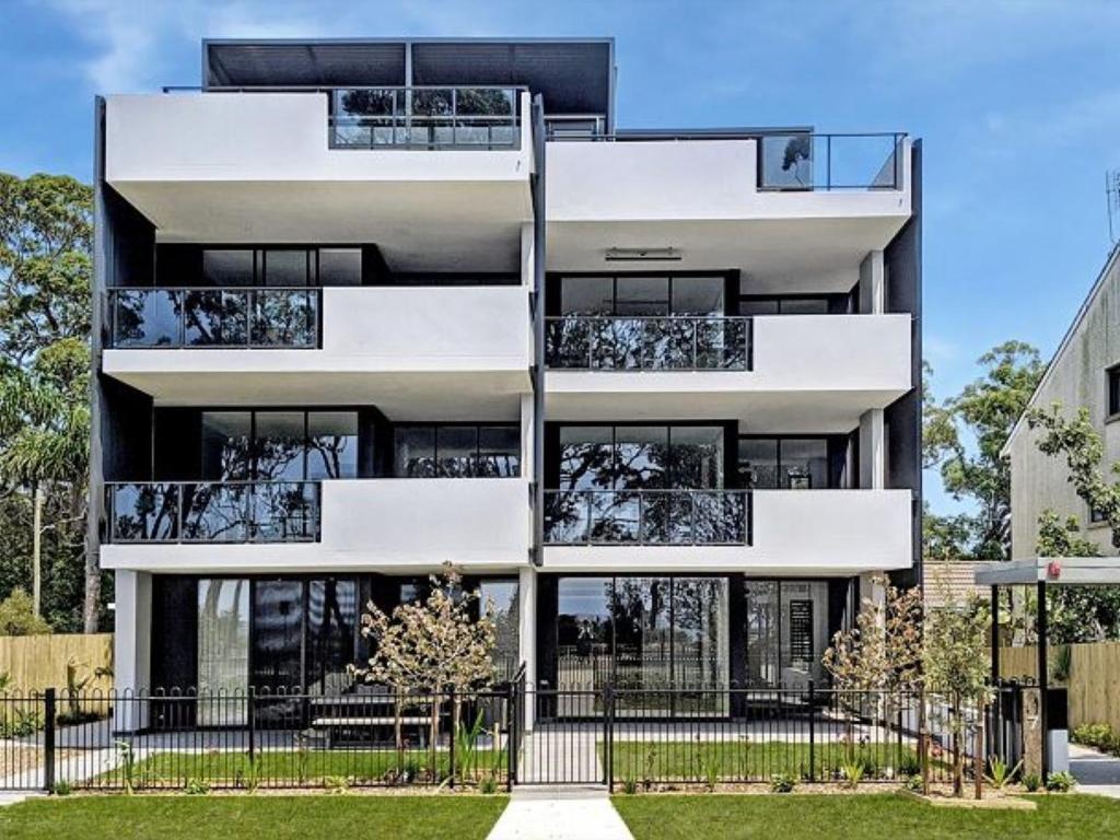 an apartment building with balconies and a fence at The Watermark by Experience Jervis Bay in Huskisson
