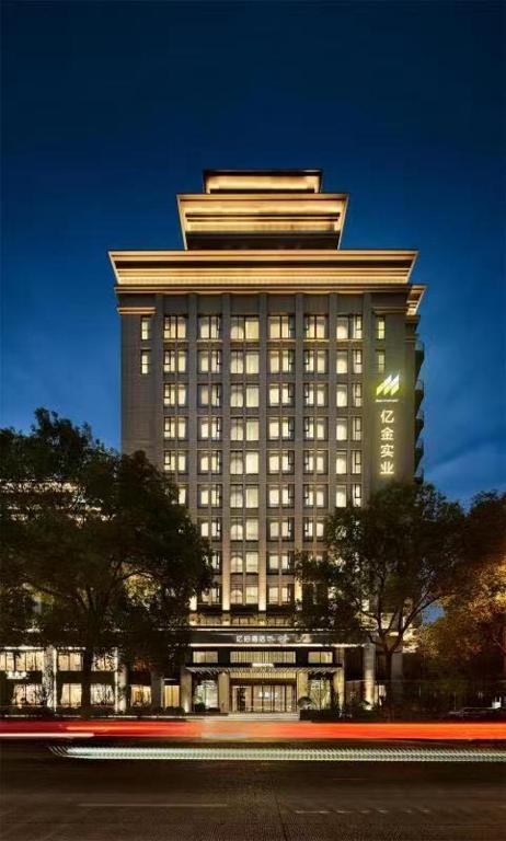 a tall building with a lot of windows on it at Ebo Hotel in Hangzhou