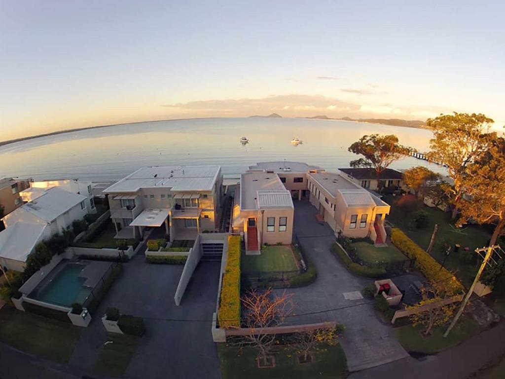 an aerial view of a house next to the water at Seaside Splendour 1 beautiful unit on the waterfront in Salamander Bay