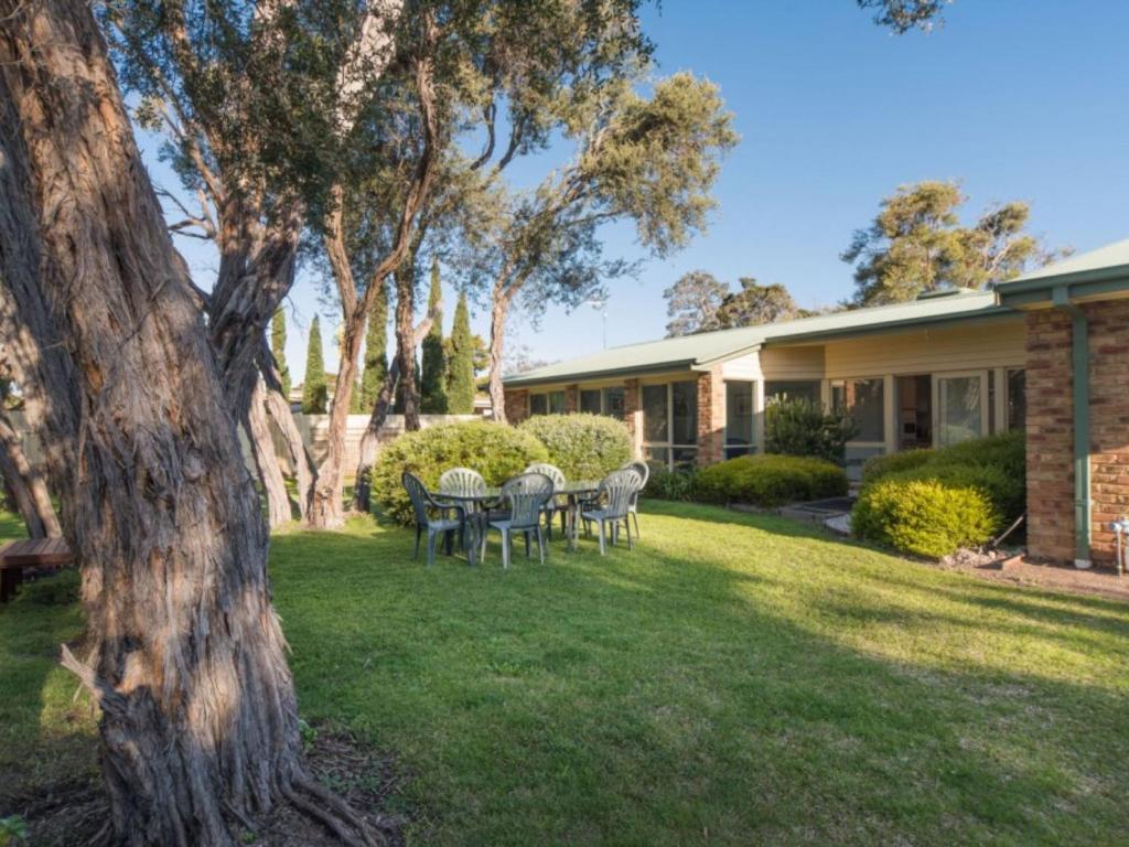 a house with a table and chairs in the yard at Bay Beach Beauty in Blairgowrie