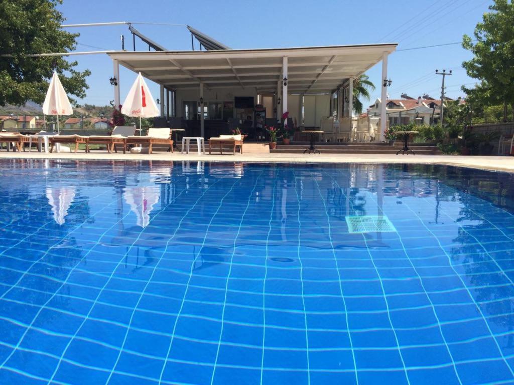 a large blue swimming pool with at Tugay Hotel in Fethiye