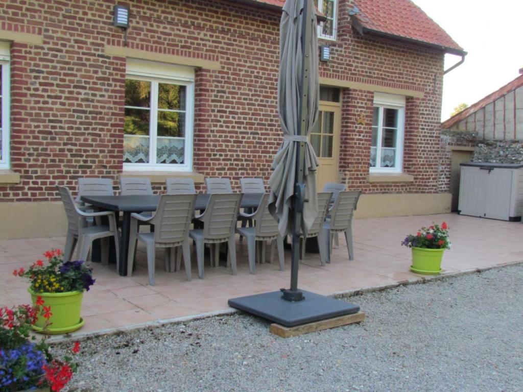 a patio with a table and chairs and an umbrella at Gîte Hubersent, 4 pièces, 10 personnes - FR-1-376-94 in Hubersent