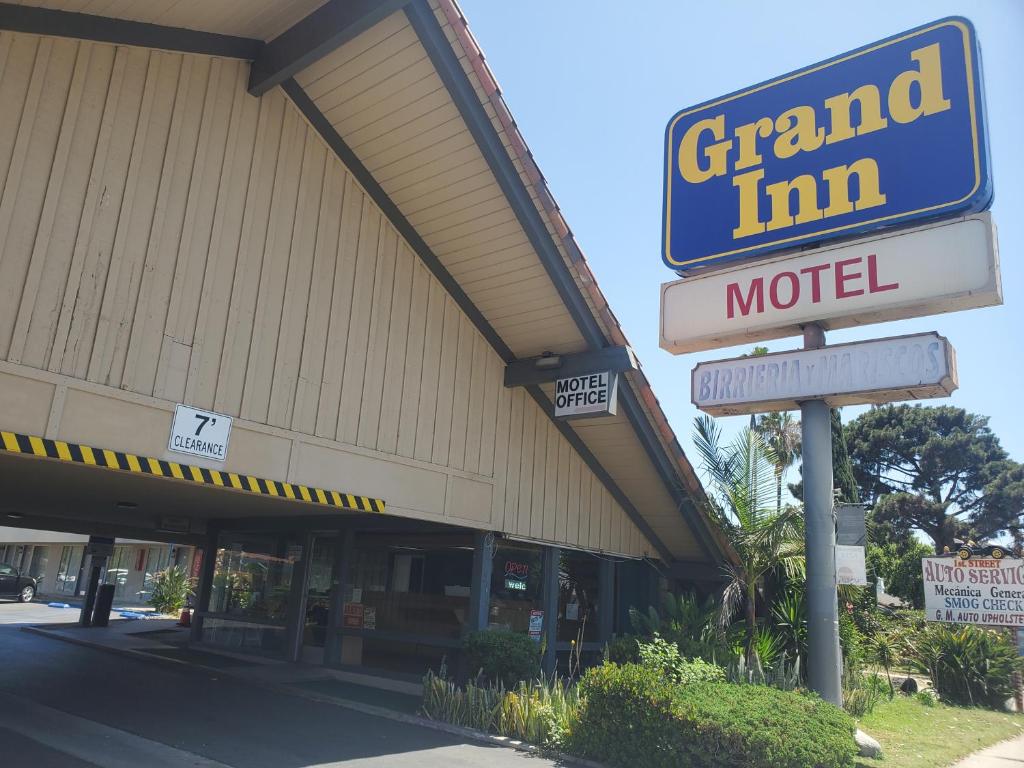 a grand inn motel sign in front of a store at Royal Grand Inn in Santa Ana