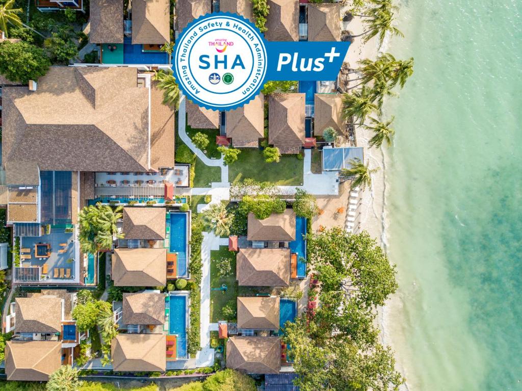 an overhead view of a resort with a hotel sign and the beach at The Briza Beach Resort, Samui - SHA Plus in Chaweng