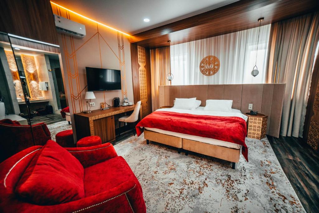 a hotel room with a bed and a couch at Алаас in Yakutsk