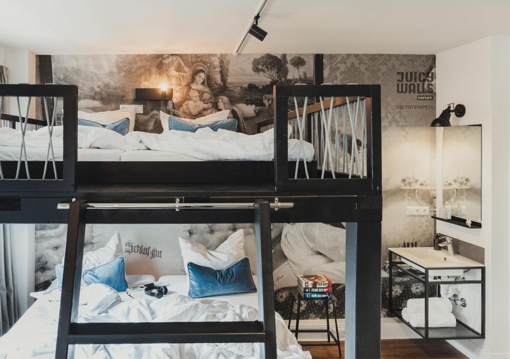 a bedroom with two bunk beds with blue pillows at Pyjama Park St. Pauli in Hamburg