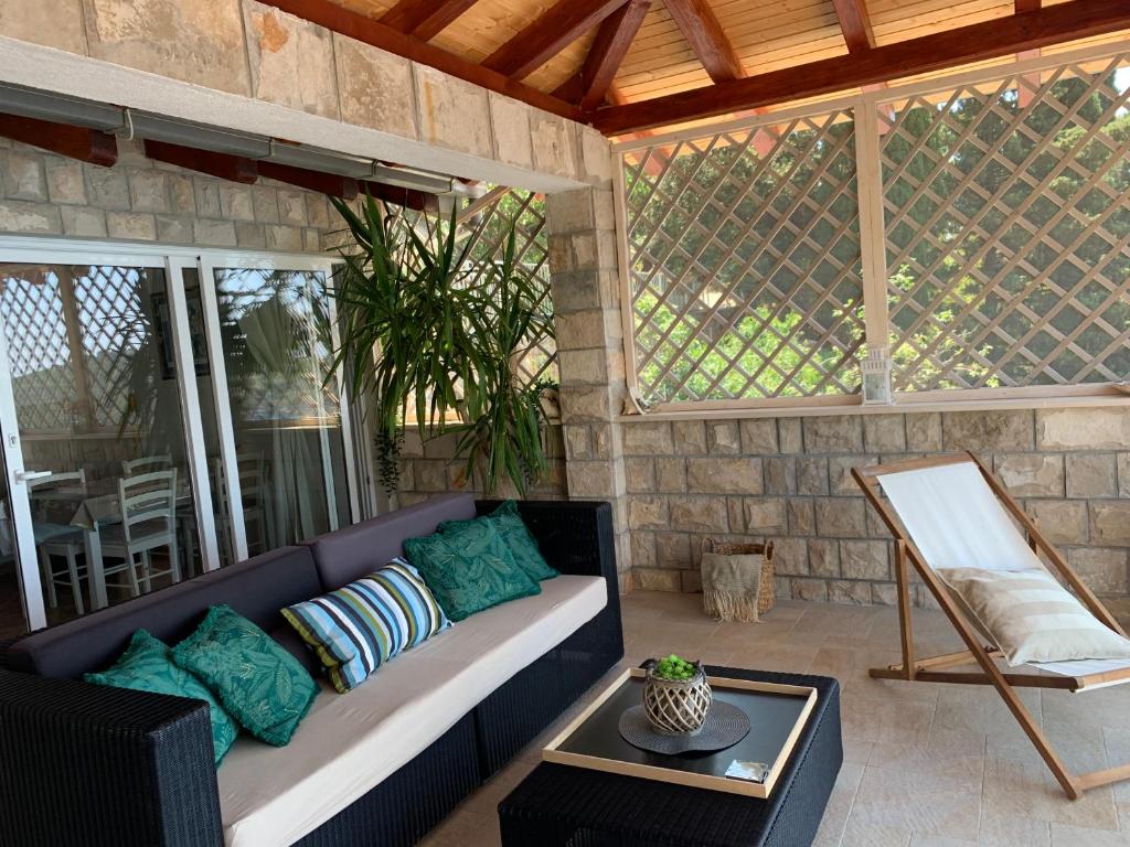 a living room with a couch and a table at Apartment and room Sveti Jakov in Dubrovnik