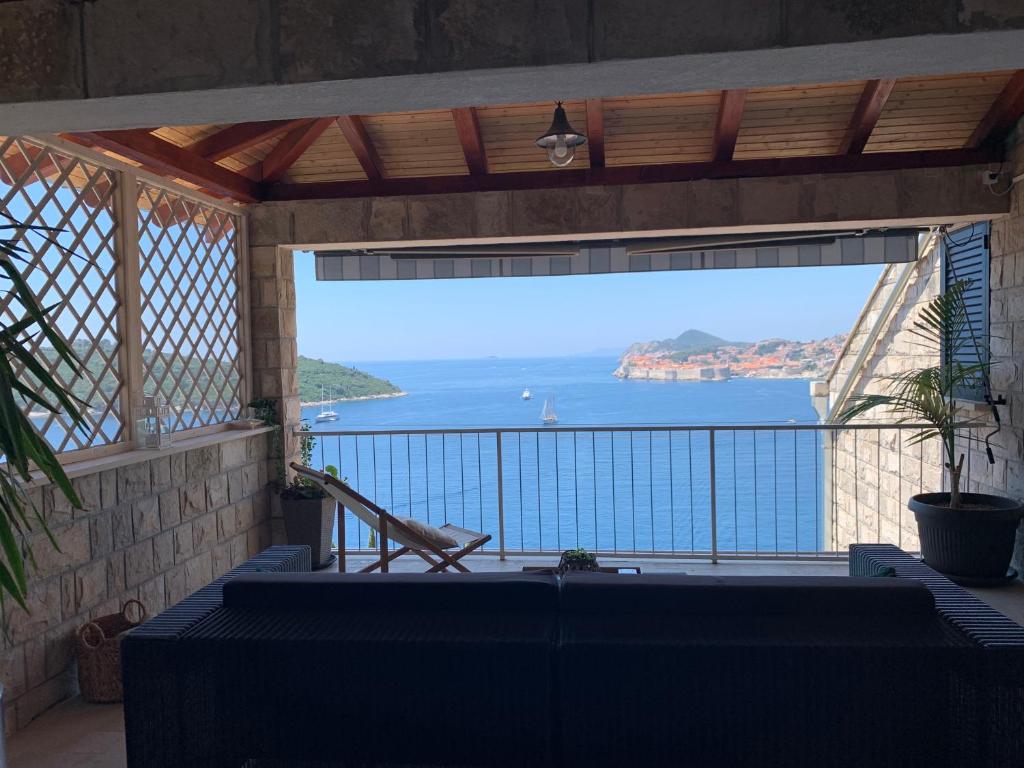 a view of the ocean from the balcony of a house at Apartment and room Sveti Jakov in Dubrovnik