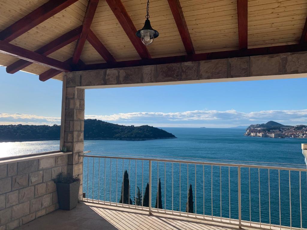 a balcony with a view of the ocean at Apartment and room Sveti Jakov in Dubrovnik