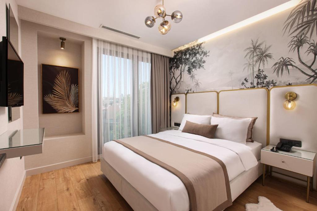 a bedroom with a large bed and a television at The Pearl Suites in Istanbul